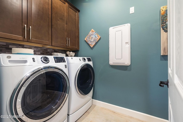 clothes washing area featuring cabinet space, independent washer and dryer, and baseboards