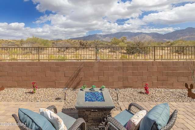 view of patio with a fenced backyard and a mountain view