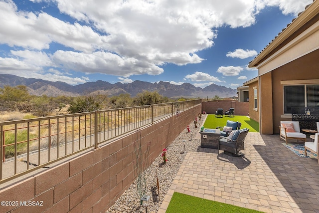 view of patio / terrace with a fenced backyard and a mountain view