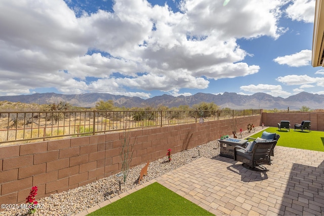 view of patio / terrace featuring a fenced backyard and a mountain view