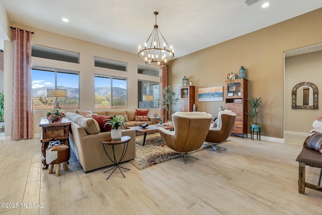 sitting room featuring light wood-type flooring, an inviting chandelier, baseboards, and recessed lighting