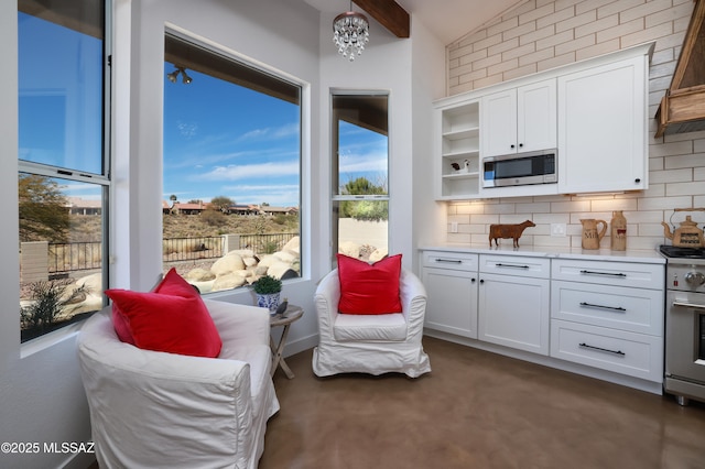 kitchen with appliances with stainless steel finishes, white cabinetry, and tasteful backsplash