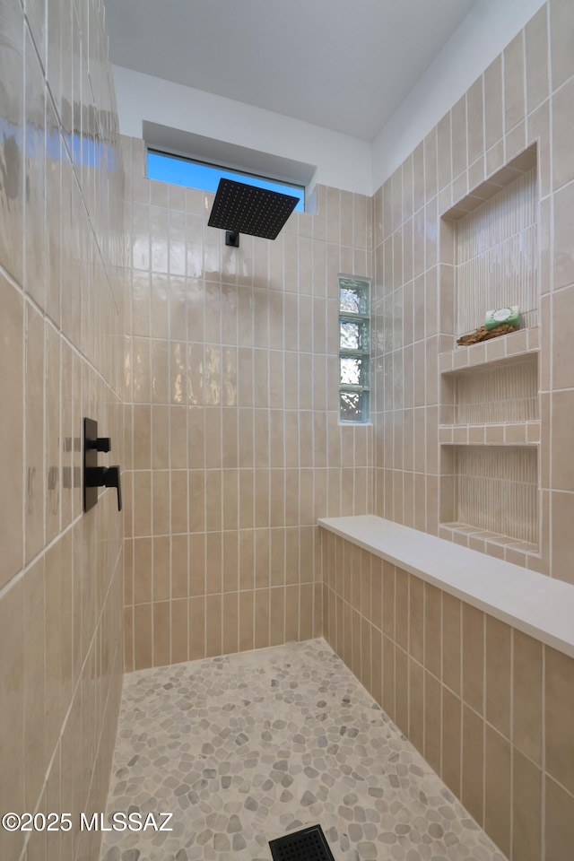 bathroom with a tile shower