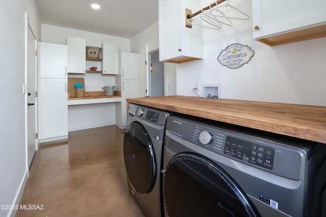 laundry room with washing machine and dryer, cabinet space, baseboards, and recessed lighting