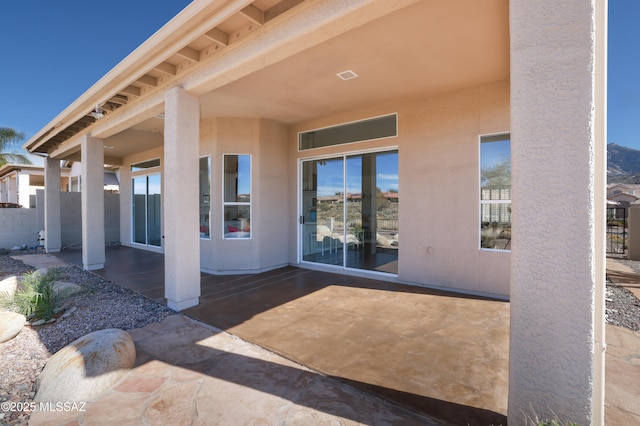 view of patio with visible vents and fence