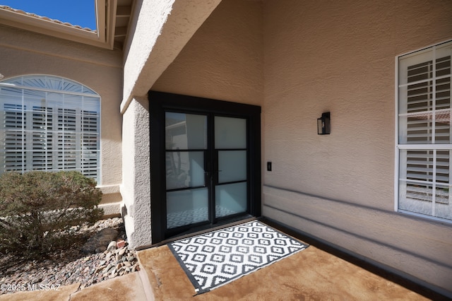 property entrance with stucco siding