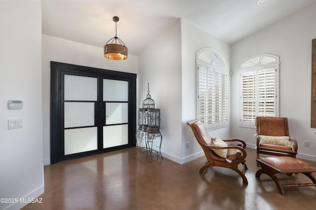 entrance foyer with baseboards and finished concrete floors