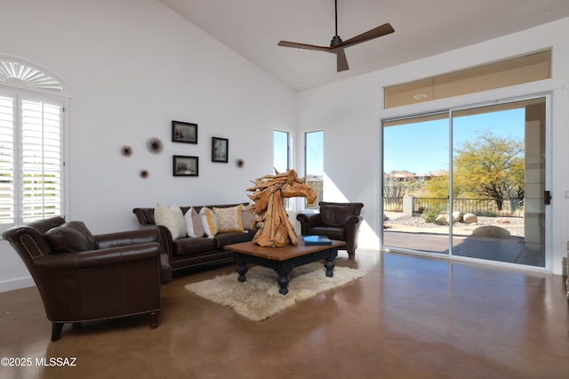 living area featuring high vaulted ceiling, a ceiling fan, and finished concrete floors