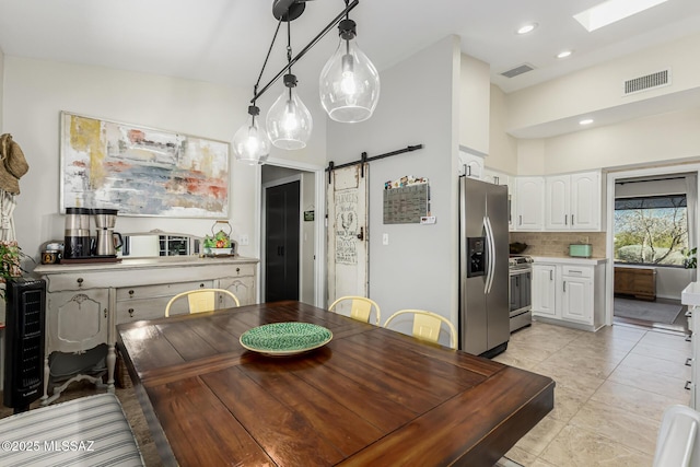 dining area with a barn door, light tile patterned flooring, recessed lighting, and visible vents