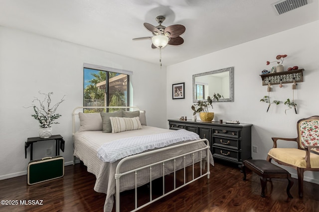 bedroom with visible vents, baseboards, and wood finished floors