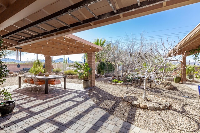 view of patio / terrace with outdoor dining space and fence