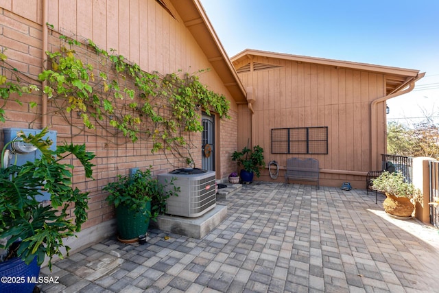view of patio / terrace with central AC unit and fence
