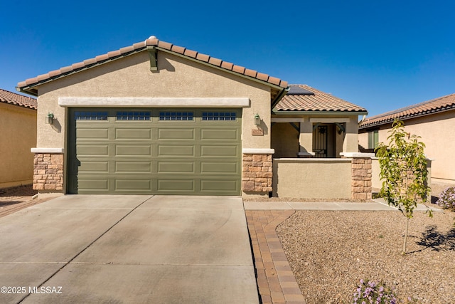 mediterranean / spanish home featuring stone siding, an attached garage, concrete driveway, and stucco siding