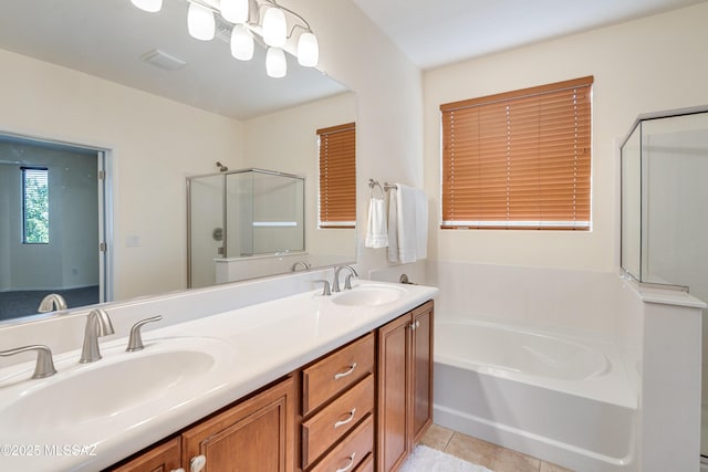 full bathroom with tile patterned floors, double vanity, a sink, and a bath