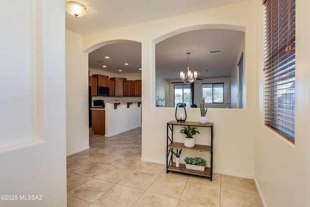 corridor with light tile patterned floors, baseboards, visible vents, and recessed lighting