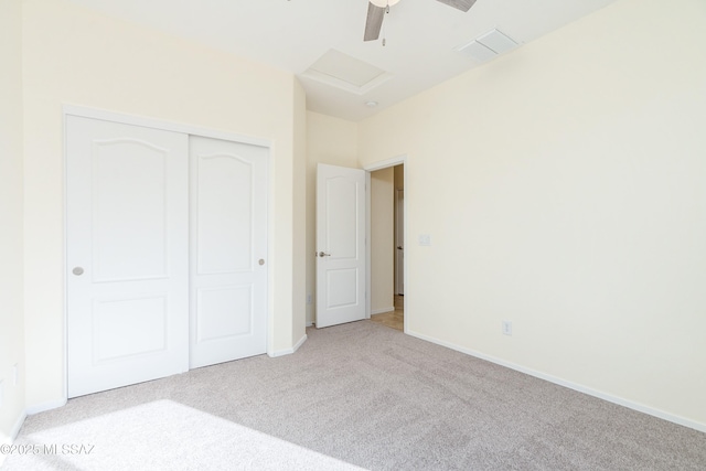 unfurnished bedroom with light colored carpet, visible vents, baseboards, a closet, and attic access