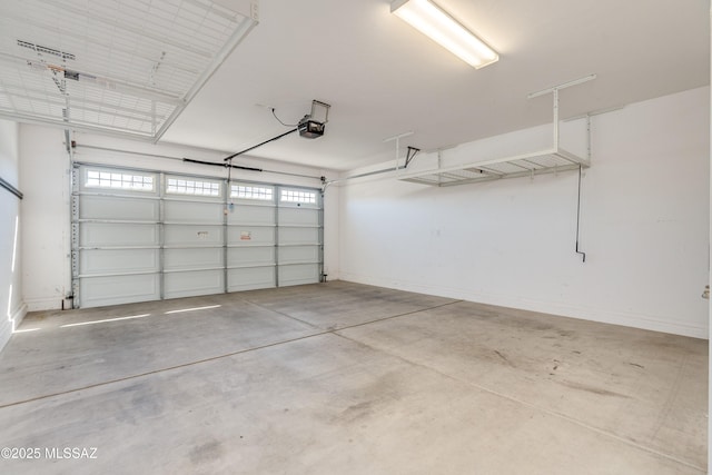 garage with baseboards and a garage door opener