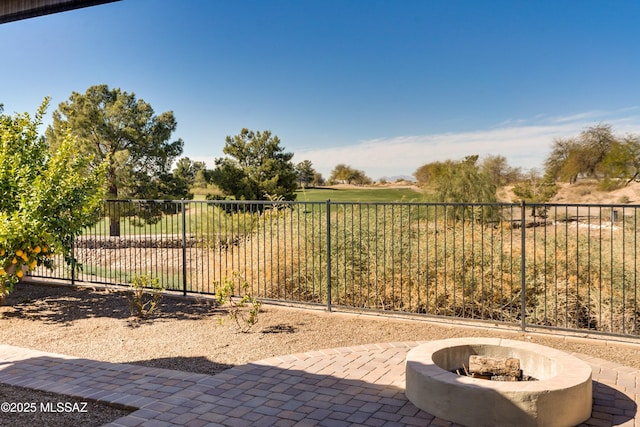 view of patio / terrace with an outdoor fire pit and fence