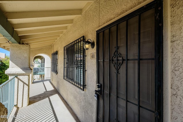 doorway to property featuring stucco siding