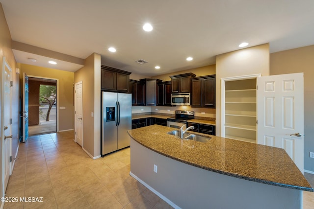10365 S High Bluff Dr, Vail, AZ 85641 - kitchen with appliances with stainless steel finishes, a sink, dark brown cabinetry, dark stone counters, and recessed lighting