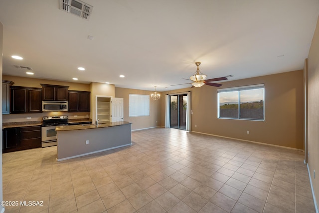 10365 S High Bluff Dr, Vail, AZ 85641 - kitchen featuring stainless steel appliances, open floor plan, a ceiling fan, a sink, and baseboards
