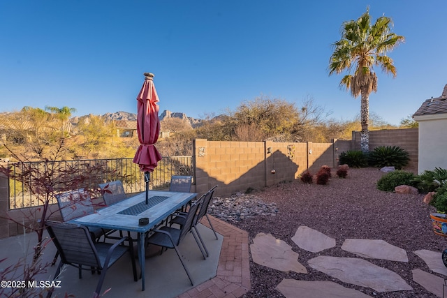 view of patio with outdoor dining area and fence