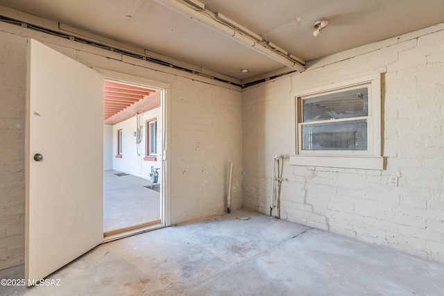 empty room with brick wall and concrete floors