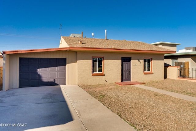 single story home with roof with shingles, driveway, an attached garage, and fence