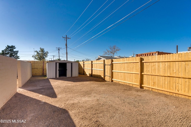 view of yard with a storage shed, a fenced backyard, and an outdoor structure