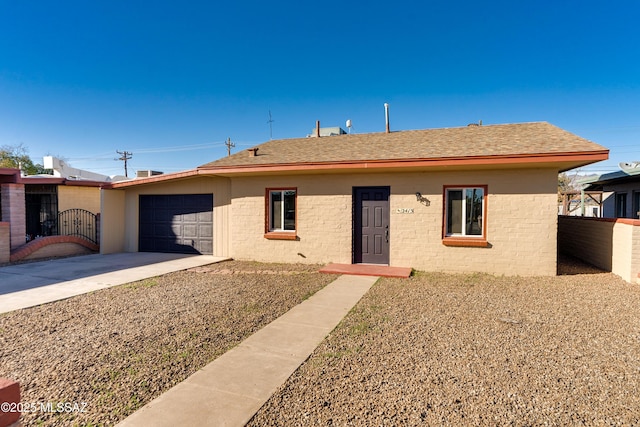 single story home with driveway, a shingled roof, a garage, and fence