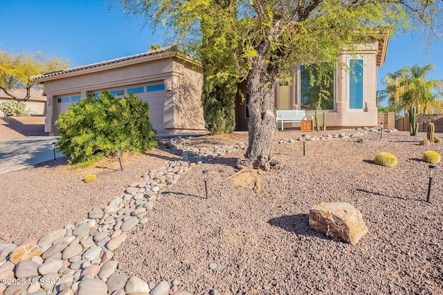 view of front facade featuring a garage and stucco siding