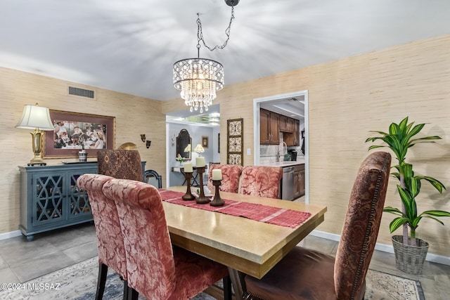 dining space with a chandelier, visible vents, and baseboards
