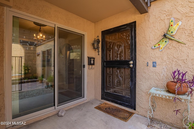 entrance to property with stucco siding