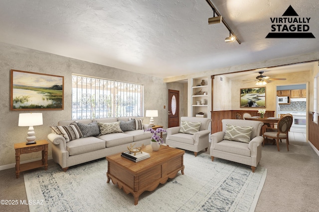 3021 E 2nd St, Tucson, AZ 85716 - carpeted living room with rail lighting, ceiling fan, and baseboards