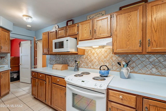 3021 E 2nd St, Tucson, AZ 85716 - kitchen featuring white appliances, under cabinet range hood, decorative backsplash, light countertops, and light tile patterned floors