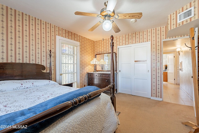 3021 E 2nd St, Tucson, AZ 85716 - tiled bedroom featuring wallpapered walls, carpet flooring, a ceiling fan, and a closet