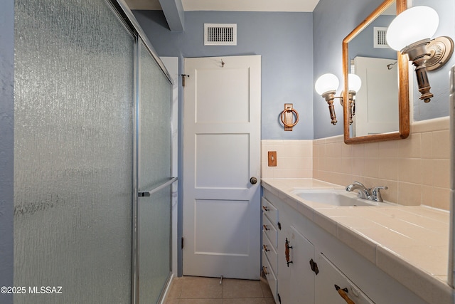 3021 E 2nd St, Tucson, AZ 85716 - bathroom featuring tile patterned flooring, a stall shower, and vanity