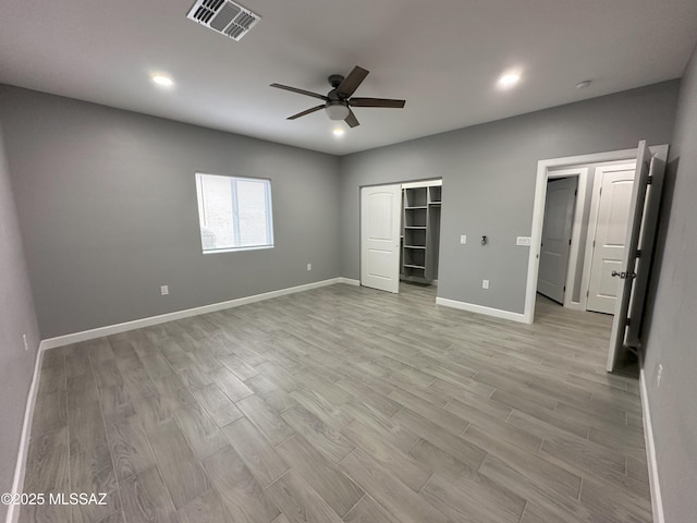 unfurnished bedroom featuring recessed lighting, visible vents, light wood-style floors, a ceiling fan, and baseboards