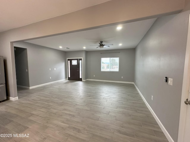unfurnished living room with recessed lighting, baseboards, ceiling fan, and light wood finished floors