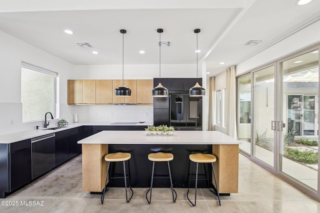 kitchen featuring light countertops, a kitchen island, a sink, modern cabinets, and dishwasher