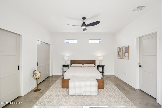 bedroom featuring baseboards, concrete floors, visible vents, and a ceiling fan