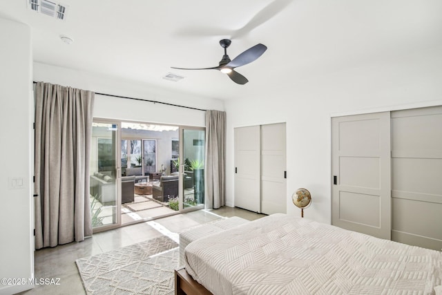 bedroom featuring a ceiling fan, multiple closets, visible vents, and access to exterior