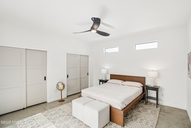 bedroom with multiple closets, a ceiling fan, baseboards, and concrete flooring