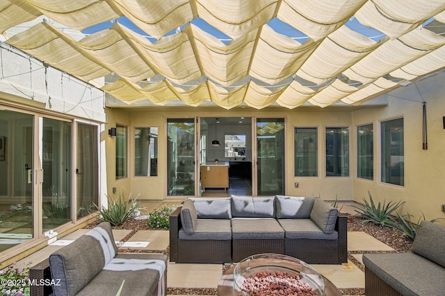 view of patio with an outdoor living space with a fire pit