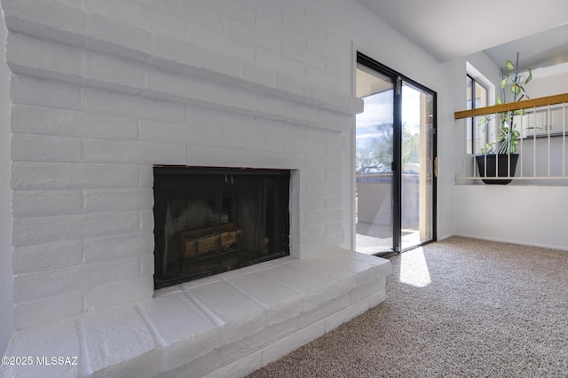 interior details with a brick fireplace and carpet flooring