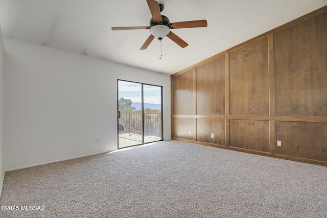 unfurnished room with ceiling fan and carpet flooring