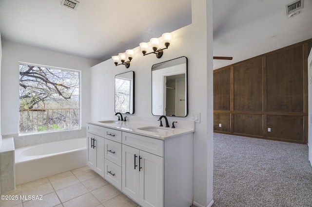 full bath featuring tile patterned floors, visible vents, a sink, and double vanity