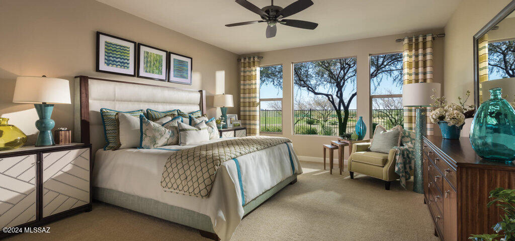 bedroom with baseboards, a ceiling fan, and light colored carpet