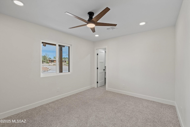 empty room with light carpet, recessed lighting, visible vents, and baseboards