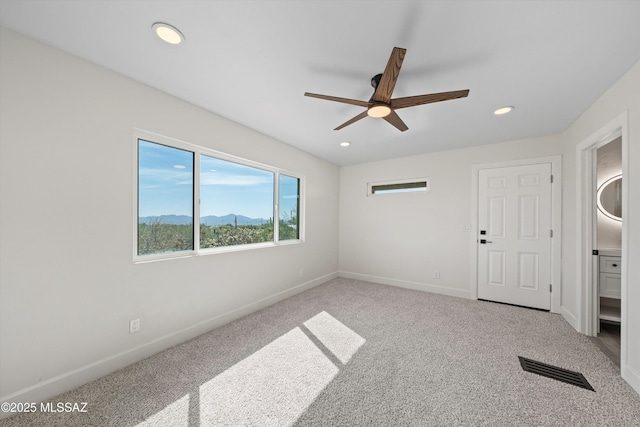unfurnished room with baseboards, carpet, visible vents, and recessed lighting